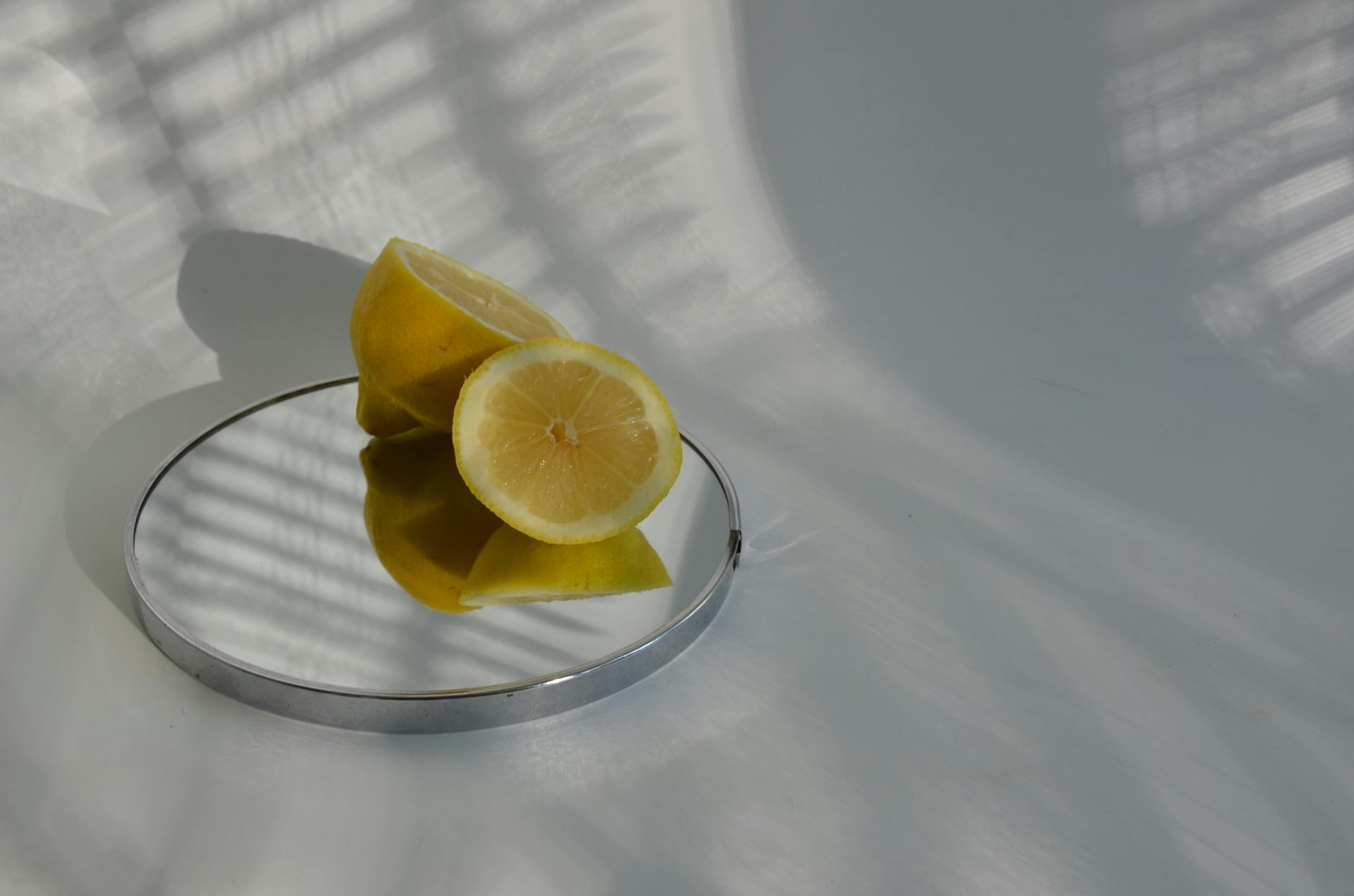 A hand holding an orange vibrator against a minimalistic purple backdrop